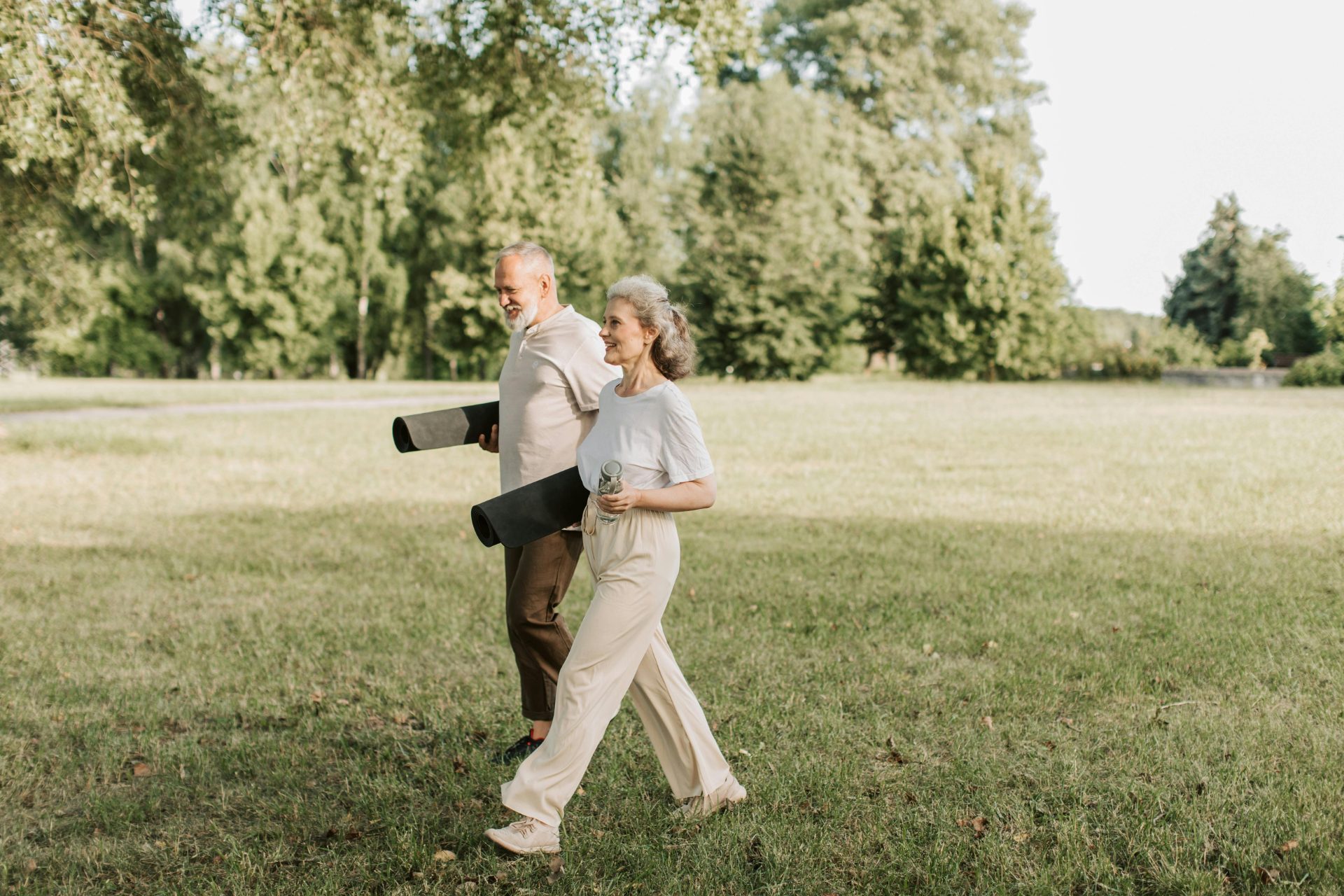 Retired couple enjoying yoga in the park